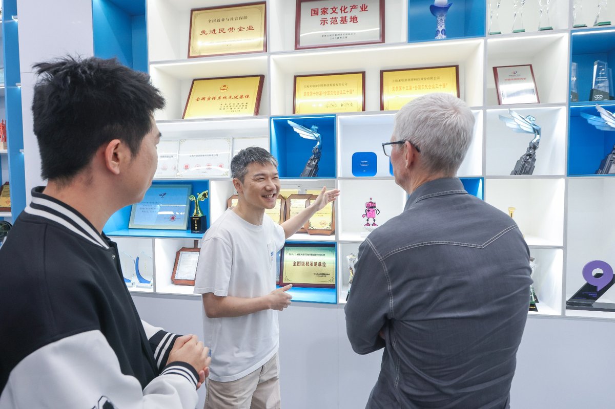 库克在米哈游奖杯墙前参观